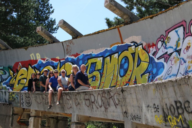 Tourists sitting on Sarajevo Bobsleigh Track